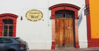 front door of a mexican restaurant housed in a white building