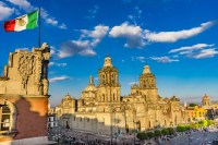 Image of grand buildings and Mexican flag.