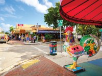 street corner in Miami with a brightly colored rooster statue