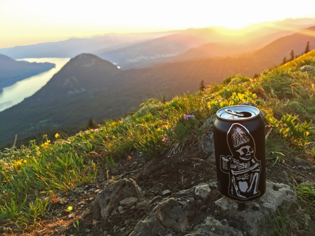 can of rogue brewers beer sitting on a hillside in oregon