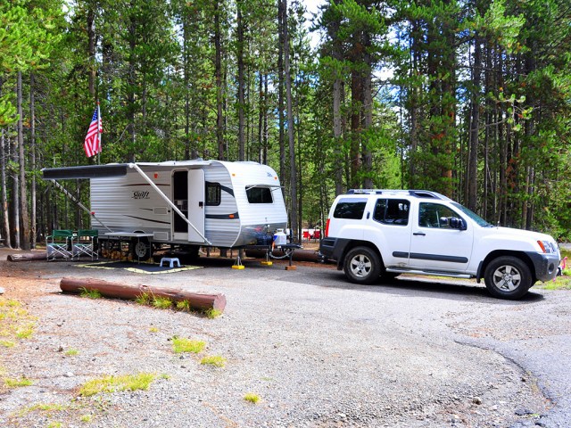 suv hitched to a travel trailer in a campground