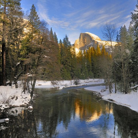 reflection of half dome on the merced river in winter