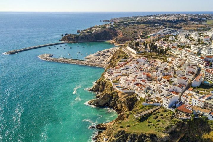 Aerial view of ocean, marina, buildings and cliffs in Albufeira, Algarve, Portugal.