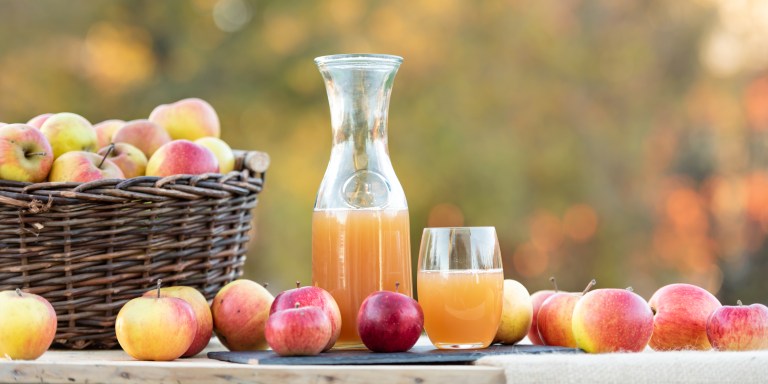 Fresh apple juice from apples in the fall after harvest, served on a table