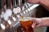 Beer being poured out a tap.