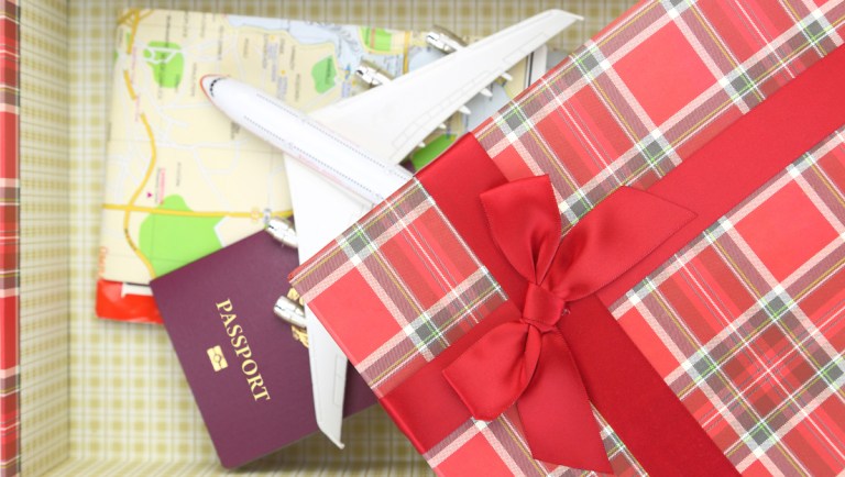 gift box with a toy airplane, map and passport