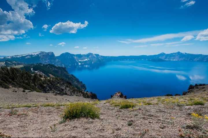 View of Crater Lake with clear blue skies and water