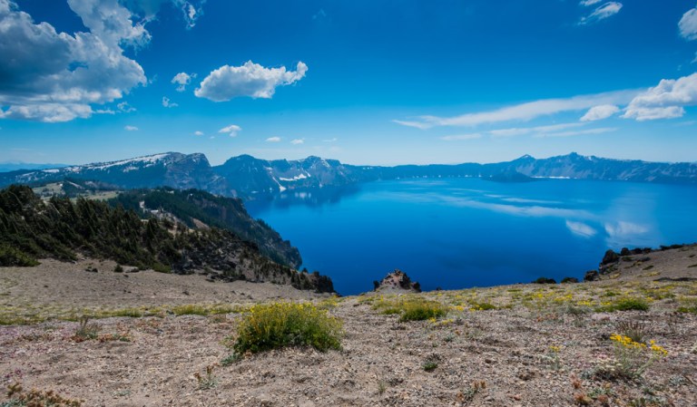View of Crater Lake with clear blue skies and water